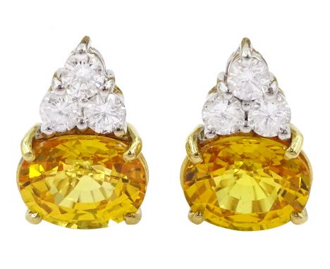 Pair of 18ct white and yellow gold round brilliant cut diamond and oval cut yellow sapphire earrings, total sapphire weight a