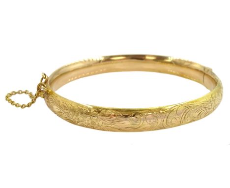 Gold hinged bangle, with engraved floral decoration, stampedCondition Report:Approx 11.05gm, stamped 375 but tested to 10.5ct