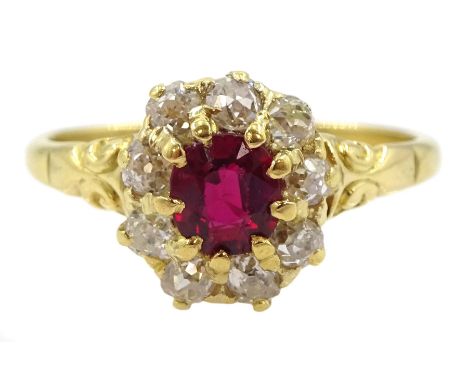 Early 20th century 18ct gold oval cut ruby and old cut diamond cluster ring, stamped, ruby approx 0.45 carat, total diamond w