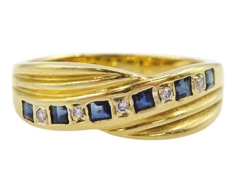 18ct gold channel set calibre cut sapphire and round cut diamond crossover ring, London import mark 1992Condition Report:Appr