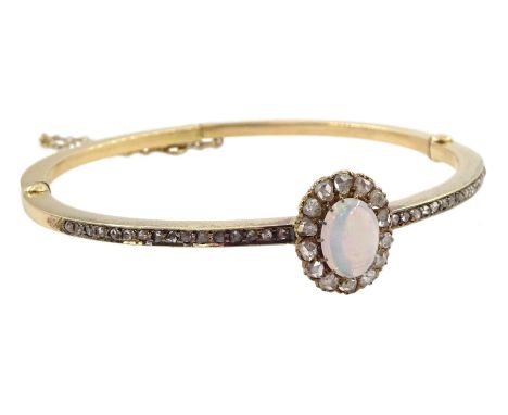Early 20th century gold opal and diamond hinged bangle, the central opal and rose cut diamond cluster, with channel set rose 