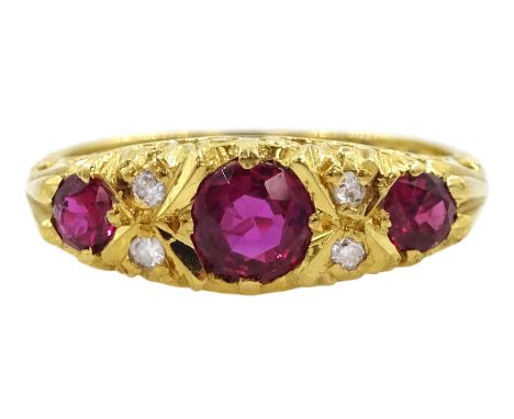 18ct gold three stone ruby ring, with four diamond accents set between, Birmingham 1975Condition Report:Approx 3.9gm, size K,