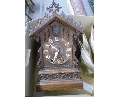 Late 19th/early 20th century oak cased cuckoo mantel clock, the chalet formed case with applied Roman numerals and decorated 