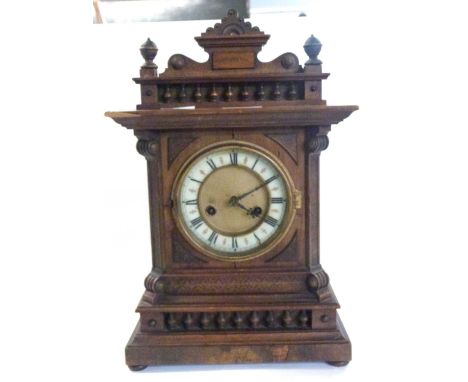 Early 20th century mantel clock with carved finial, 43cm high