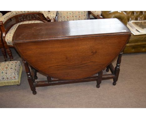18th Century oak gate leg table raised on turned legs with an oval drop leaf top, 104cm wide