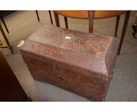 An unusual 19th Century leather mounted and brass studded trunk of sarcophagus form, 80cm wide