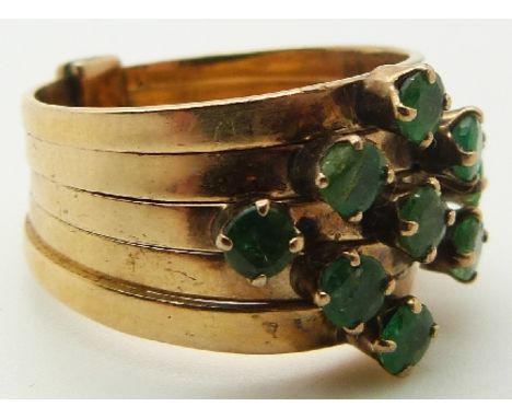 A 14k gold ring made up of five bands set with nine round cut emeralds, 5.5g, size K