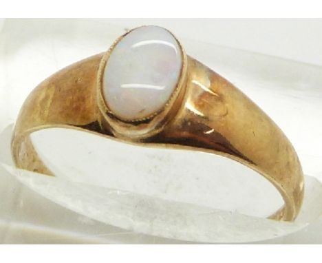 A 9ct gold ring set with an opal cabochon, 1.6g, size N