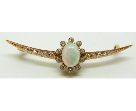 A late Victorian crescent shaped brooch set with an oval opal cabochon and diamonds, in original box, length 5.5cm