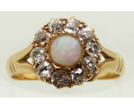 Victorian 18ct gold ring set with an opal cabochon surrounded by old cut diamonds, size J, in original box&nbsp;