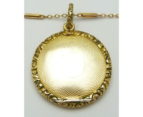 A 9ct gold necklace (2.5g)and Victorian locket with engine turned decoration and textured border, length 2.5cm