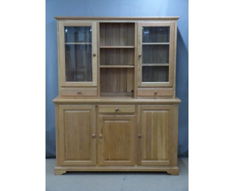 Modern light oak dresser, the top having shelves flanked by glazed display cupboards with drawers below, the base fitted cent