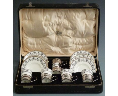 Cased set of George V hallmarked silver mounted Aynsley coffee cups and saucers, Birmingham 1924, weight of silver 79g, the c