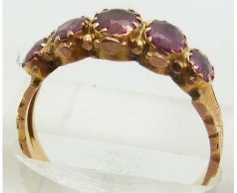 A 9ct gold ring set with garnets, 2.3g, size R