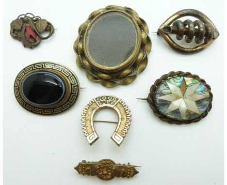 Victorian pinchbeck brooch set with black enamel and banded agate, a horseshoe brooch reading Good Luck and further Victorian