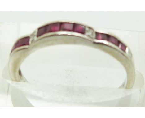 An 18ct white gold ring set with square step cut rubies and four diamonds, 2g, size L