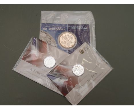 Royal Mint two 'Timeless First' £20 silver coins, together with a 2001 silver Britannia