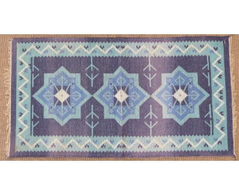 Retro 60's/70's kilim with deep blue ground and central star design, 127 x 67cm