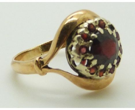 A 9ct gold ring set with garnets, 3.1g, size K&nbsp;