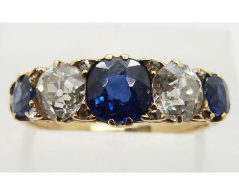 An 18ct gold ring set with three sapphires, the centre stone measuring approximately 1ct, and two diamonds each approximately