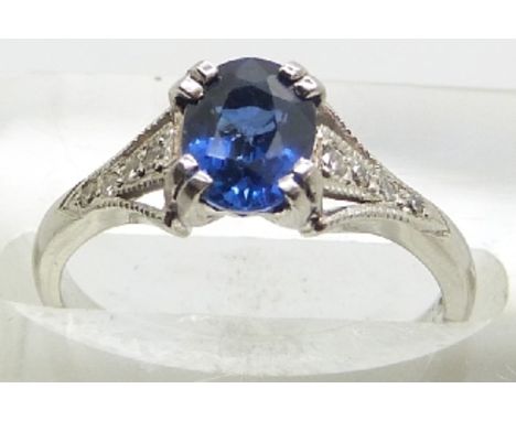 A platinum ring set with an oval cut sapphire of approximately 1ct and diamonds to the shoulders, 3.8g, size J/K&nbsp;