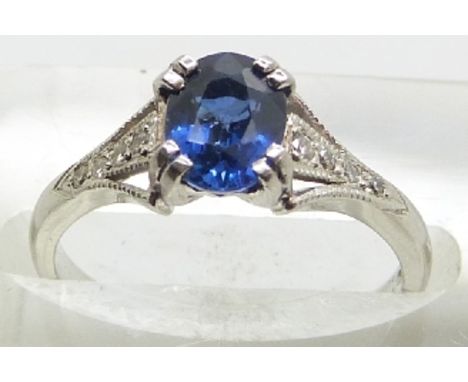 A platinum ring set with an oval cut sapphire of approximately 1ct and diamonds to the shoulders, 3.8g, size J/K&nbsp;