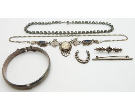 A silver bangle, cameo and filigree necklace, Victorian silver brooch, silver horseshoe and paste necklace
