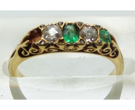 An 18ct gold ring set with diamonds and emeralds in original box, size K