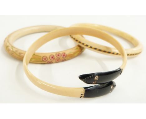 A 1920's Art Deco ivory flapper bangle with elephant hair to the centre, Art Deco snake flapper bangle and one other