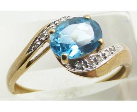 A 9ct gold ring set with a blue topaz and diamonds, 2.6g, size S