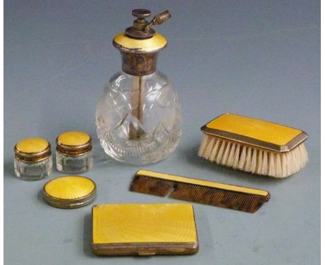 Five yellow guilloché enamel silver mounted dressing table items, comprising atomiser marked Sterling and comb, brush and two