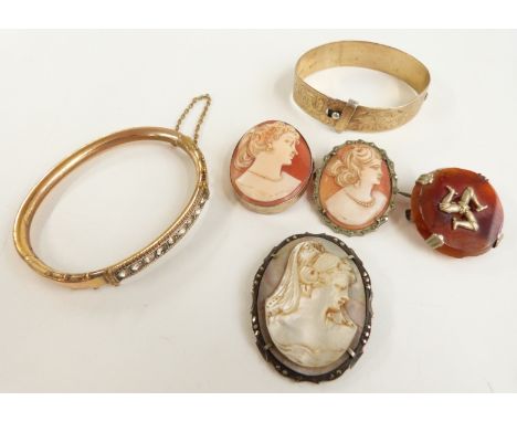 Three cameo brooches, a gold plated bangle and a Victorian gold plated bangle set with paste&nbsp;