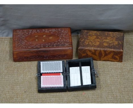 Two carved wooden boxes, one with brass inlay and a bridge/playing card set