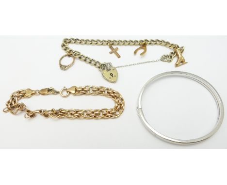 A silver gilt bracelet with four 9ct gold charms, 9ct gold bracelet and a 9ct white gold bangle, 14.6g