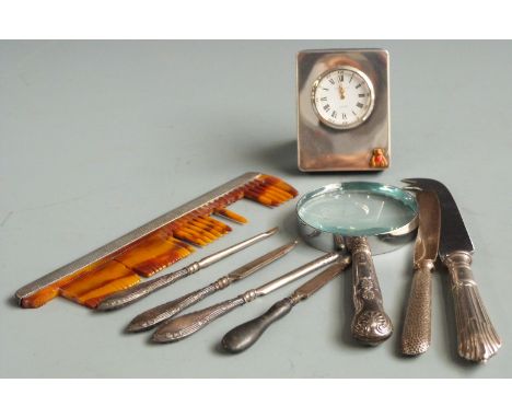 Quantity of hallmarked silver mounted items to include small clock, magnifying glass, comb, knives etc
