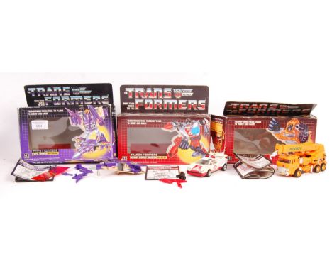 Three original vintage boxed Hasbro made Transformers action figure toys comprising: Autobot Architect Grapple, Security Dire