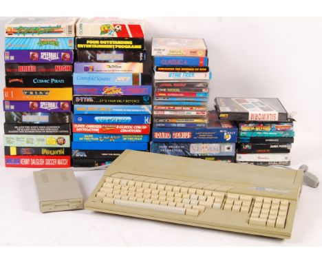 A vintage Atari ST video games computer console with A/C adaptor, mouse, Quick shot joysticks, and a large collection of 40+ 