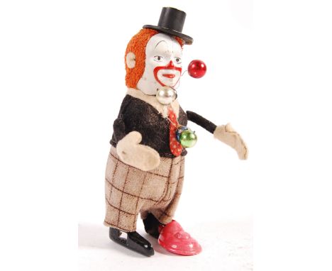 A rare antique vintage 1940's German Schuco made clockwork tinplate wind up toy dancing juggling clown. Figure appears good w