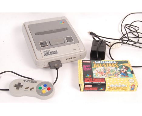 An original vintage SNES Super Nintendo Entertainment System video games computer console with original A/C adaptor, aerial c