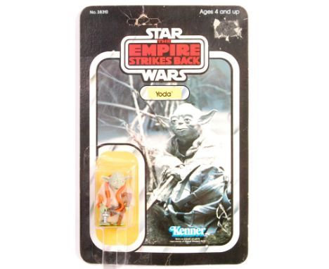 An original vintage Kenner made Star Wars carded MOC action figure ' Yoda ' (Orange Snake). On it's original 32 back Empire S