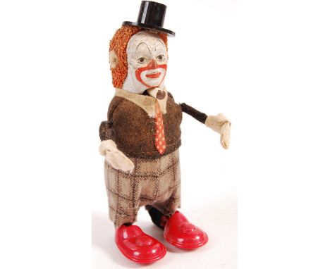 A rare antique vintage 1940's German Schuco made clockwork tinplate wind up toy dancing juggling clown. Figure appears good w