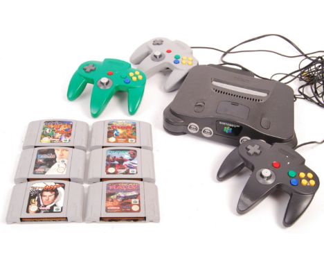 An original vintage Nintendo made N64 / Nintendo 64 games console. Along with x3 original controllers, power lead, and 6x ori