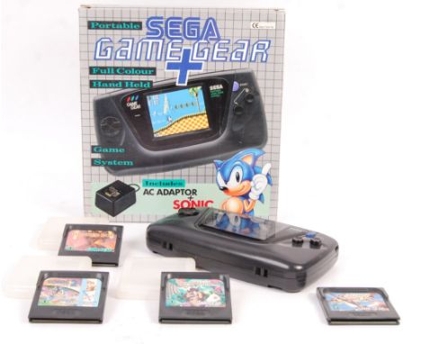 A vintage Sega Game Gear handheld portable video games computer console complete in box with A/C adaptor, console and Sonic g