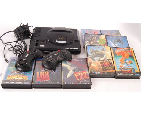 A vintage Sega Mega Drive 16-Bit video games computer console with aerial, official A/C adaptor and 2x control pads along wit