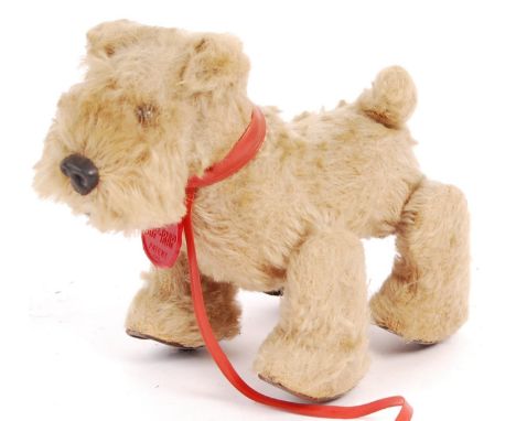 A rare vintage 1950's Schuco made German ' Trip Trap ' pull-along dog. Blonde mohair, with original collar with makers tag. W