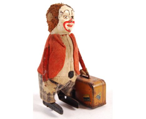 A rare antique vintage 1930's pre war German Schuco made clockwork tinplate wind up toy No. 786 Clown with suitcase / briefca