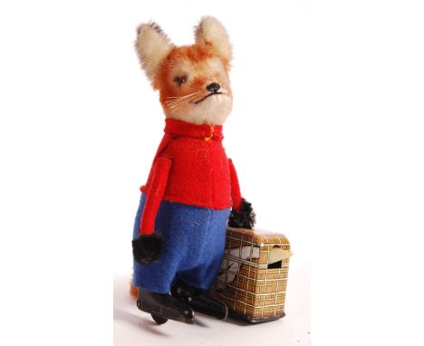 A rare antique vintage 1950's German Schuco made clockwork tinplate wind up toy No 969 Fantastic Mr Fox with goose in suitcas