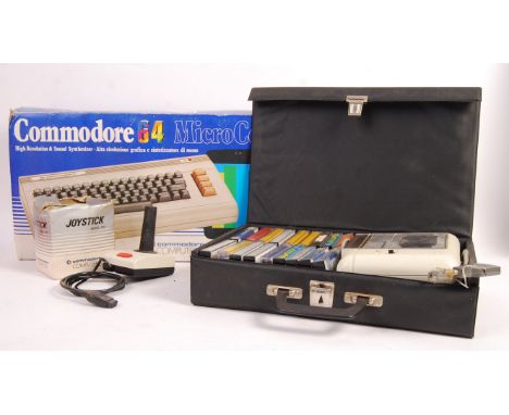 An original vintage Commodore 64 Micro Computer games console appearing complete in original box along with a quantity of gam