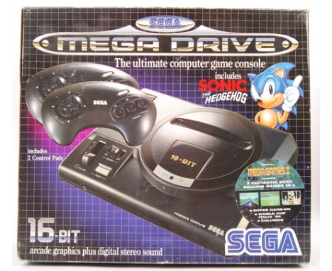 A boxed vintage Sega Mega Drive 16-Bit video games computer console with aerial, official A/C adaptor, 2x control pads with S