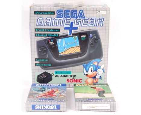 A vintage Sega Game Gear handheld portable video games computer console complete in box with A/C adaptor, console and Sonic g